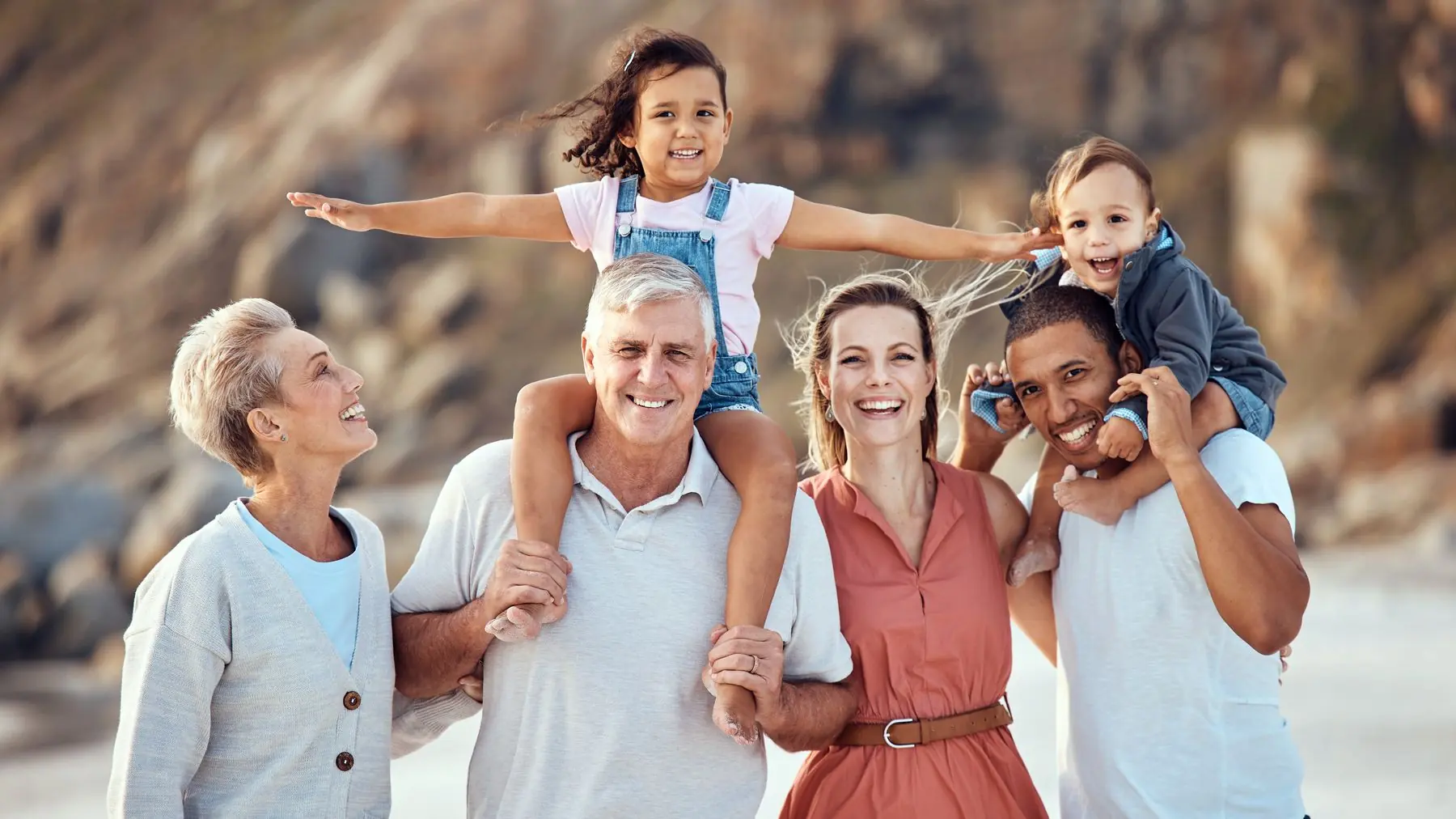 Three generations of a family together on a beach
